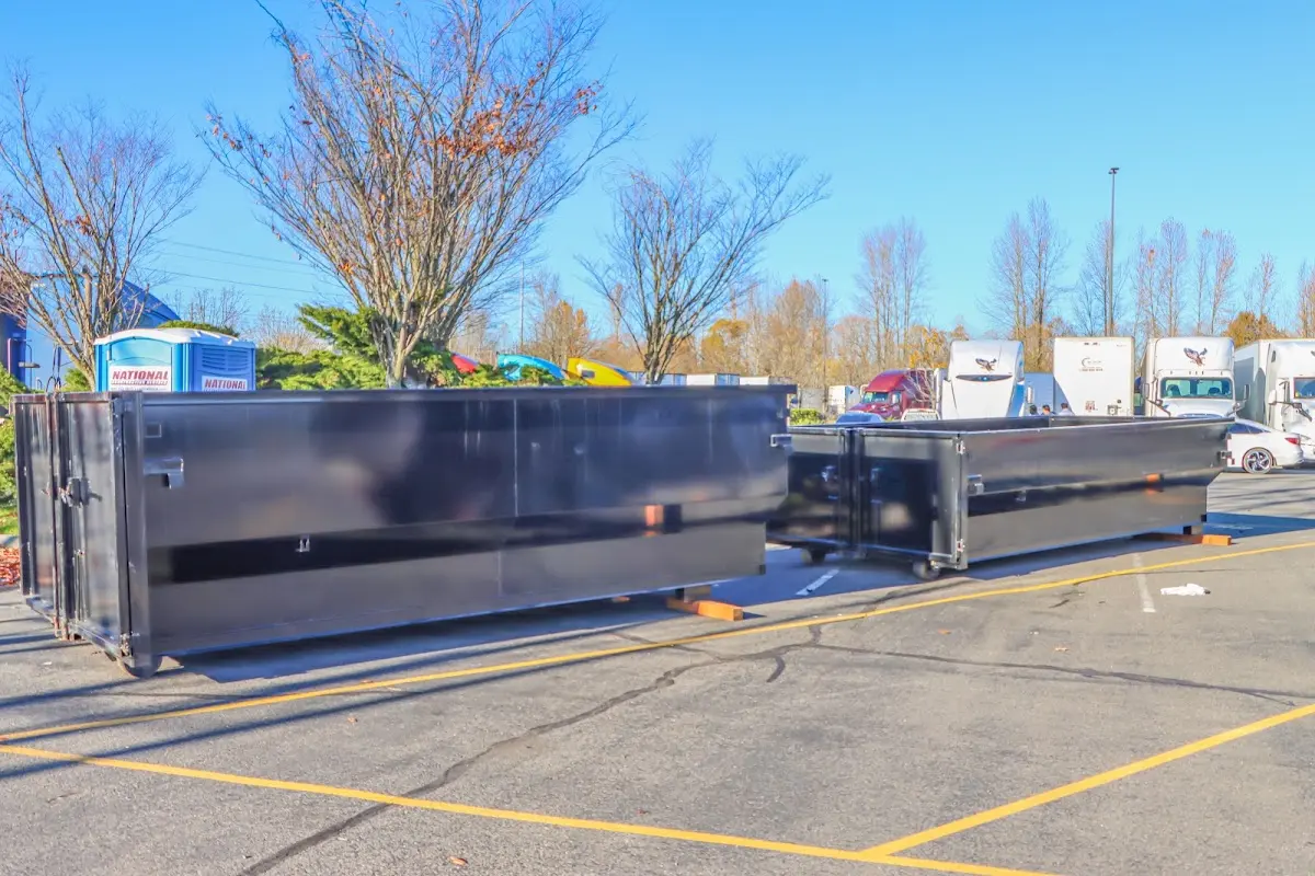 Professional dumpster rental service with roll-off container on residential driveway in Sharon Hill